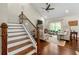 Comfortable living room showcasing hardwood floors, a cozy seating area, and staircase leading to the upper floor at 5015 Monticello Dr, Villa Rica, GA 30180