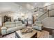Open concept living room with a view of the kitchen, staircase, and hardwood floors at 5015 Monticello Dr, Villa Rica, GA 30180