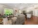 An open-concept living room and kitchen area with natural light and hardwood floors throughout the home at 5015 Monticello Dr, Villa Rica, GA 30180