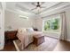 Bedroom featuring large windows, wood floors, and a tray ceiling at 5015 Monticello Dr, Villa Rica, GA 30180