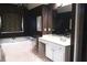 Soaking tub beneath a window paired with a beautiful vanity in this well-appointed bathroom at 555 Stoneglen Sw, Atlanta, GA 30331