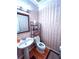 Charming half bathroom with pedestal sink and elegant wallpaper at 555 Stoneglen Sw, Atlanta, GA 30331