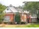 Beautiful brick two-story home with a manicured lawn and mature trees at 555 Stoneglen Sw, Atlanta, GA 30331