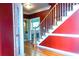 Foyer with hardwood floors, staircase, and stylish red accent wall at 555 Stoneglen Sw, Atlanta, GA 30331