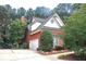 Side view of brick home with two-car garage and manicured landscaping at 555 Stoneglen Sw, Atlanta, GA 30331