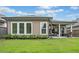 Home's back exterior showing the covered patio and well-maintained lawn at 205 Floral Valley Dr, Woodstock, GA 30188