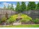 Landscaped backyard featuring a charming rock waterfall, adding serenity to the outdoor space at 205 Floral Valley Dr, Woodstock, GA 30188