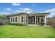 Grassy backyard featuring a covered patio seating area at 205 Floral Valley Dr, Woodstock, GA 30188