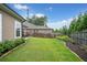 Backyard featuring a well-maintained lawn, privacy fence, and manicured landscaping at 205 Floral Valley Dr, Woodstock, GA 30188