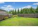Spacious backyard with lush lawn and privacy fence, ideal for outdoor activities at 205 Floral Valley Dr, Woodstock, GA 30188