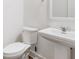 Bathroom featuring a pedestal sink and toilet, offering a simple and functional design at 205 Floral Valley Dr, Woodstock, GA 30188