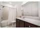Well-lit bathroom featuring a shower-tub combo, toilet, and vanity with a white countertop at 205 Floral Valley Dr, Woodstock, GA 30188