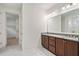 Elegant bathroom with double sinks, granite countertops, and ample storage in dark wood cabinets at 205 Floral Valley Dr, Woodstock, GA 30188