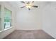 Bedroom featuring carpet flooring, a ceiling fan, natural lighting, and bare walls for decorating at 205 Floral Valley Dr, Woodstock, GA 30188
