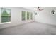 Spacious bedroom with ample natural light, thanks to the large windows, complete with plush carpeting at 205 Floral Valley Dr, Woodstock, GA 30188