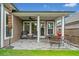 Relaxing covered patio with ceiling fan, outdoor seating, and a view of the yard at 205 Floral Valley Dr, Woodstock, GA 30188