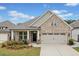 Charming brick home with a two-car garage, landscaped yard, and inviting front porch at 205 Floral Valley Dr, Woodstock, GA 30188