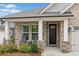 Inviting front porch with stone pillars and outdoor seating, perfect for relaxing at 205 Floral Valley Dr, Woodstock, GA 30188