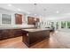 Modern kitchen with dark wood cabinetry, granite counters, and a large center island at 205 Floral Valley Dr, Woodstock, GA 30188