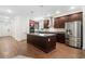 Spacious kitchen featuring stainless steel appliances, island, and hardwood flooring at 205 Floral Valley Dr, Woodstock, GA 30188