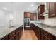 A gourmet kitchen featuring stainless appliances, granite countertops, and dark wood cabinetry at 205 Floral Valley Dr, Woodstock, GA 30188