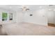 Open carpeted living area featuring two windows and bare walls for decorating at 205 Floral Valley Dr, Woodstock, GA 30188
