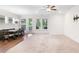 Carpeted living area adjacent to the dining area and showing a TV mounted on the wall at 205 Floral Valley Dr, Woodstock, GA 30188