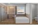 Bright bathroom featuring a glass-enclosed shower and a separate soaking tub at 2536 Dayview Ln, Atlanta, GA 30331