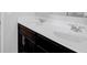 Bathroom vanity featuring double sinks, modern faucets, and dark cabinetry at 2536 Dayview Ln, Atlanta, GA 30331