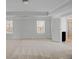 Bedroom boasting a tray ceiling, two windows, and an ensuite bathroom with a shower at 2536 Dayview Ln, Atlanta, GA 30331