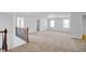 Spacious open landing area with neutral carpet and staircase with dark wood railing at 2536 Dayview Ln, Atlanta, GA 30331