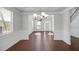 Bright dining room featuring hardwood floors, decorative wainscoting and a chandelier at 2536 Dayview Ln, Atlanta, GA 30331