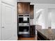 Built-in double oven and cabinets with granite countertop in a modern kitchen at 2536 Dayview Ln, Atlanta, GA 30331