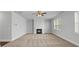 Living room featuring a fireplace, ceiling fan, and large windows with blinds at 2536 Dayview Ln, Atlanta, GA 30331
