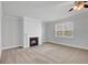 Carpeted living room featuring a fireplace and large windows with blinds at 2536 Dayview Ln, Atlanta, GA 30331