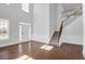 Bright, open-concept living area with soaring ceilings, hardwood floors, and a staircase to the second floor at 2536 Dayview Ln, Atlanta, GA 30331