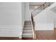 Carpeted staircase with decorative wood and iron railing and decorative wainscoting at 2536 Dayview Ln, Atlanta, GA 30331