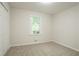 Neutral bedroom with carpet, window, fresh paint, and closet ready for personalization at 356 Waterway Trl, Powder Springs, GA 30127