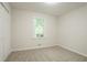 Bright bedroom with neutral carpet, a large window overlooking the yard and double-door closet for ample storage at 356 Waterway Trl, Powder Springs, GA 30127