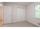Bedroom with neutral carpet and a double-door closet for ample storage at 356 Waterway Trl, Powder Springs, GA 30127