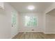 Bright dining room with light wood floors and a large window overlooking the yard at 356 Waterway Trl, Powder Springs, GA 30127