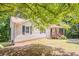 This charming one-story home features mature trees and a covered front porch at 356 Waterway Trl, Powder Springs, GA 30127