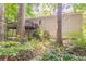 The rear of the home features a large wooden deck and is surrounded by lush foliage at 356 Waterway Trl, Powder Springs, GA 30127