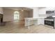 Open kitchen featuring new stainless steel appliances and an eat-in breakfast bar at 356 Waterway Trl, Powder Springs, GA 30127