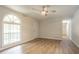 Spacious living room with light wood floors, large window, ceiling fan, and white walls at 356 Waterway Trl, Powder Springs, GA 30127