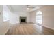 Bright living room featuring a stone fireplace, ceiling fan, and large window at 356 Waterway Trl, Powder Springs, GA 30127