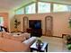 Bright living room with large windows, neutral decor and cozy seating arrangement at 1260 Willeo Creek Dr, Roswell, GA 30075