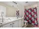 Bathroom with double sink vanity and floral shower curtain, offering a clean and functional space at 485 Greyhawk Way, Fairburn, GA 30213