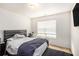 Bedroom with a large bed, dark rug, and natural light from the window at 485 Greyhawk Way, Fairburn, GA 30213