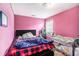 Cozy bedroom with pink walls, bed, and crib, perfect for a Bedroom or young  at 485 Greyhawk Way, Fairburn, GA 30213
